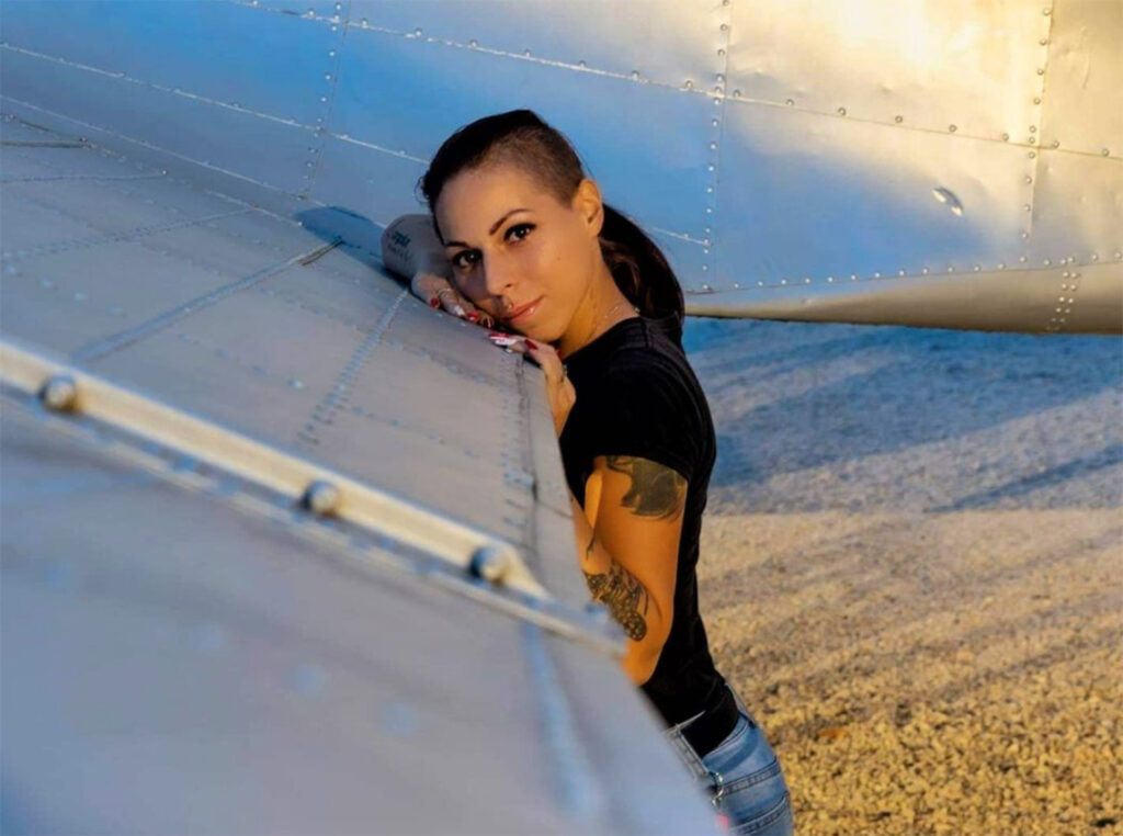 Sandra resting against a real plane