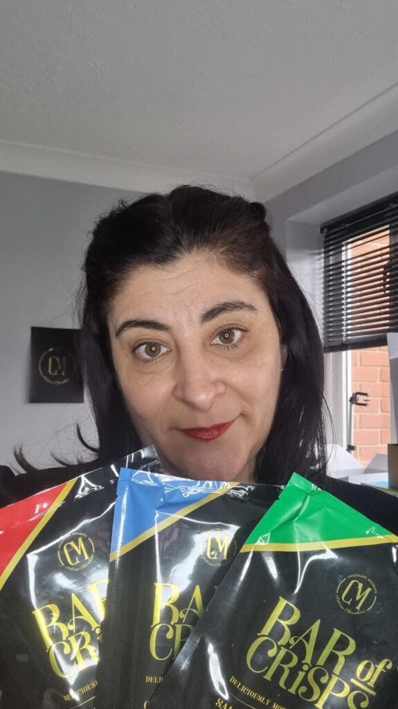 Maria holds up three flavours of her 'Bar of Crisps.'