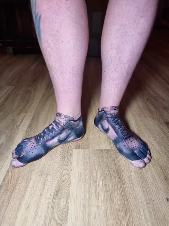 The Nike style tattoo can be seen on both of the man's feet