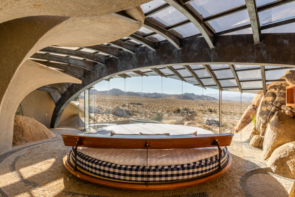 A rounded bed sits looking out on the incredible views of Joshua Tree.